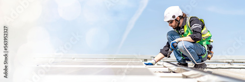 Web banner Male engineer installing or checking the working condition of solar panels on the roof or at the height of the factory for saving electricity was broken to use renewable energy from the sun
