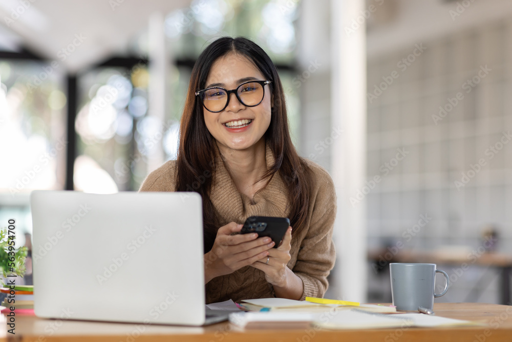 Portrait of Happy Excited young asian woman at workplace office desk, successful Asian female reading good news technology online, employee freelance finance concepts. Portrait of Happy Excited young asian woman at workplace office desk, successful Asian female reading good news technology online, employee freelance finance concepts.