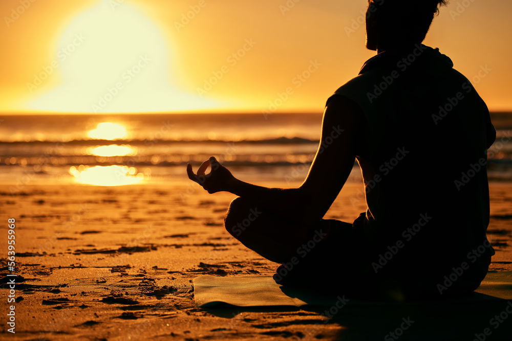 Meditation, lotus and silhouette of man at beach outdoors for health and wellness. Sunset, zen yoga and shadow or outline of male yogi meditating, chakra training and mindfulness exercise at seashore