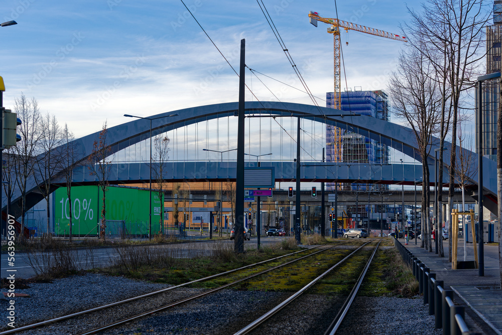 Tramway with tracks of tram line four and modern foot bridge in the background at City of Zürich on a blue cloudy winter day. Photo taken January 2nd, 2023, Zurich, Switzerland. Tramway with tracks of tram line four and modern foot bridge in the background at City of Zürich on a blue cloudy winter day. Photo taken January 2nd, 2023, Zurich, Switzerland.