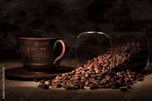 Coffee beans spilled out of the jar onto the table in the kitchen 

