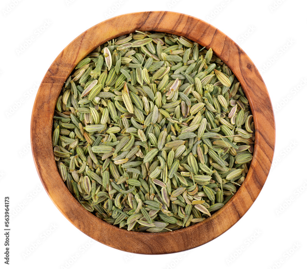Fennel seeds in wooden bowl, isolated on white background. Green fennel grains. Spices and herbs. Top view. Fennel seeds in wooden bowl, isolated on white background. Green fennel grains. Spices and herbs. Top view.