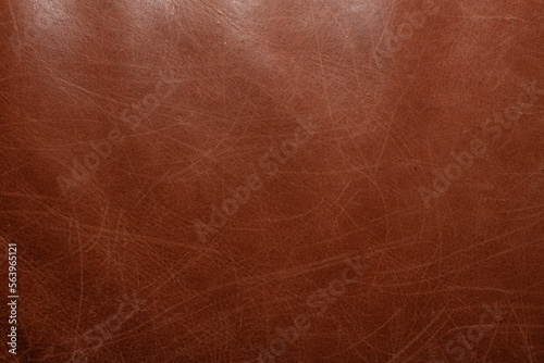 Closeup on old brown leather texture with scratches