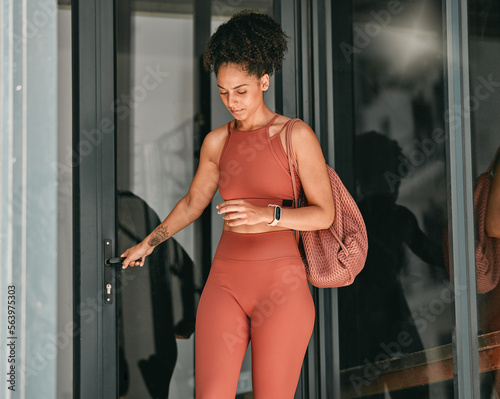 Ready, welcome and door with black woman in gym for workout, exercise and motivation. Training, wellness and sports with girl athlete and bag for cardio, endurance and stamina goal lifestyle