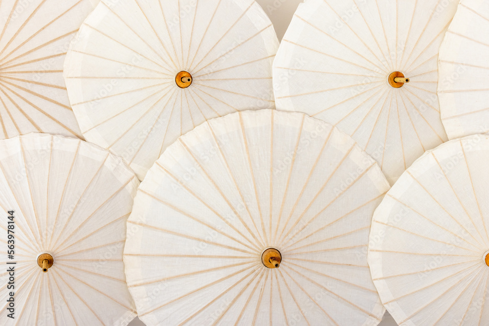 Hand made white paper umbrella with wood splines on  background, Background, hand made umbrella, paper umbrella, Thai culture.