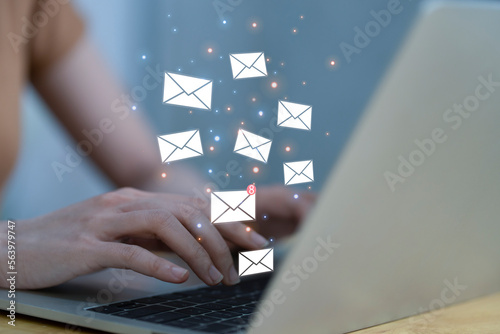 Mail Online Message Global Communications Connection Concept. Hand of businessman using laptop with e-mail icon. woman sending e-mail message to mailing list contacts using computer, photo