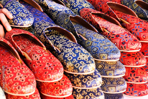Colorful Handmade chappals (sandals) being sold in an Indian market, Handmade leather slippers, Traditional footwear. © Vinayak Jagtap
