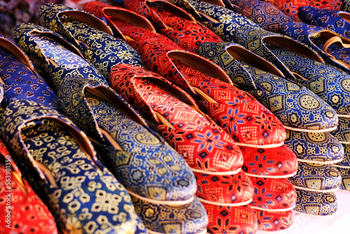 Colorful Handmade chappals (sandals) being sold in an Indian market, Handmade leather slippers, Traditional footwear.