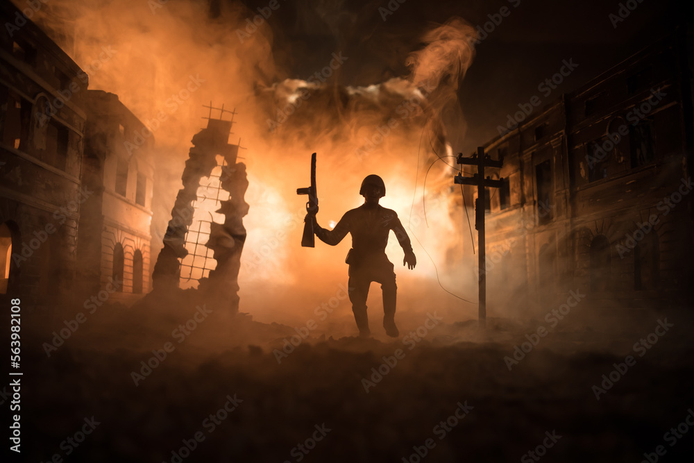 War Concept. Military silhouettes fighting scene on war fog sky background, World War Soldiers Silhouette Below Cloudy Skyline At night. Battle in ruined city.