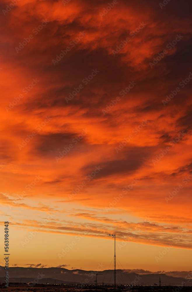 A pink and reddish sunset with clouds