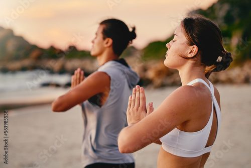 Yoga couple, prayer hands and meditation at beach.outdoors for health and wellness. Sunset, pilates fitness and man and woman with namaste hand pose for training, calm peace and mindfulness exercise.