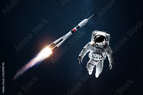 Fototapeta Naklejka Na Ścianę i Meble -  Astronaut in a white spacesuit in space against the backdrop of a rocket. Exploration of space and other planets, colonization of the solar system. Copy space, 3D illustration, 3D renderer.