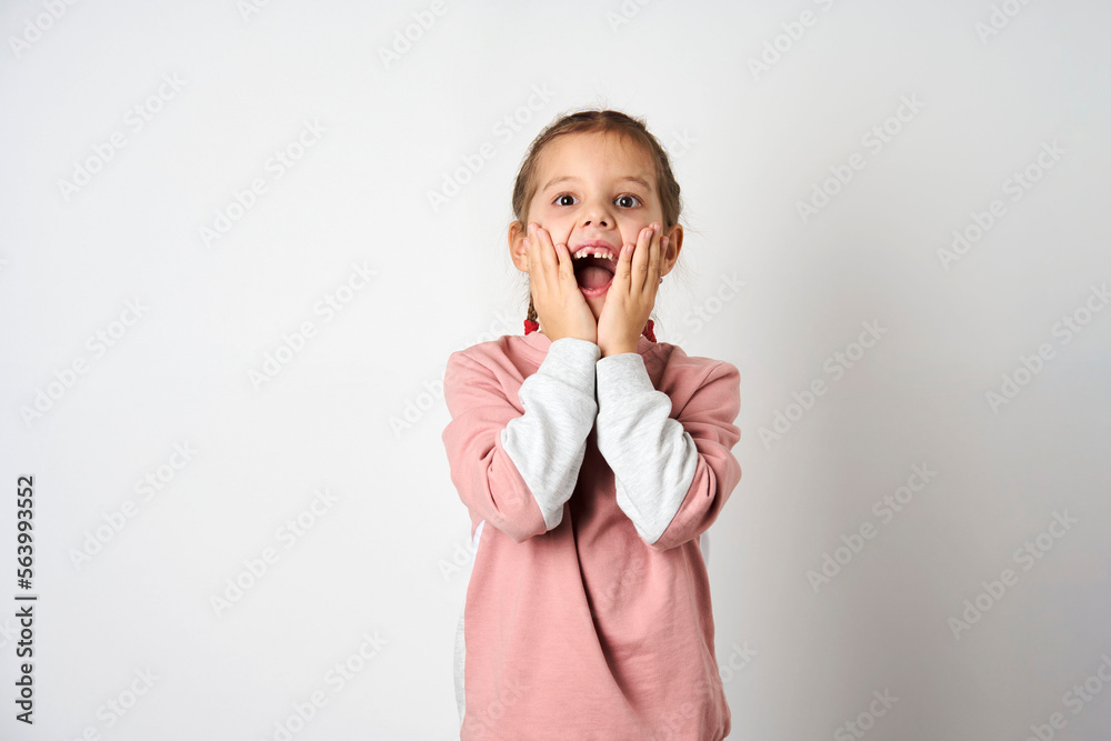 Portrait of impressed cute girl hands on cheeks open mouth Portrait of impressed cute girl hands on cheeks open mouth