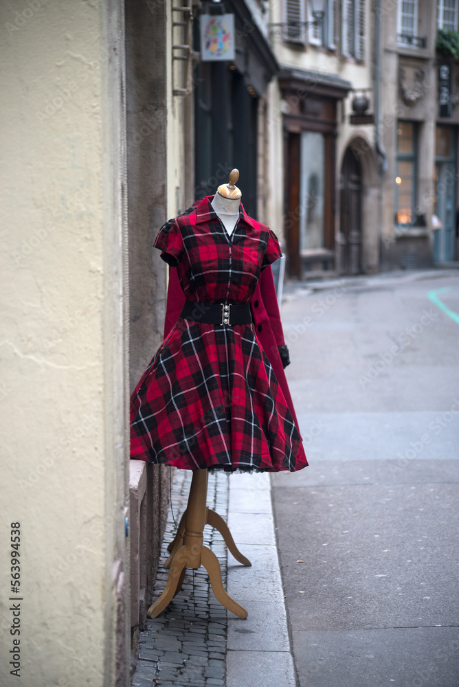 View of red vintage gothic dress on hanger in the street