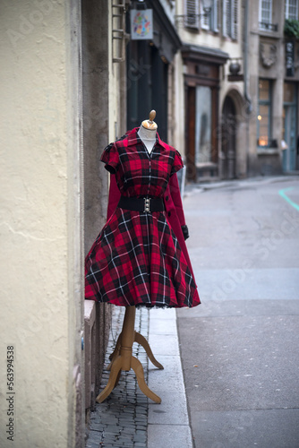 View of red vintage gothic dress on hanger in the street © pixarno