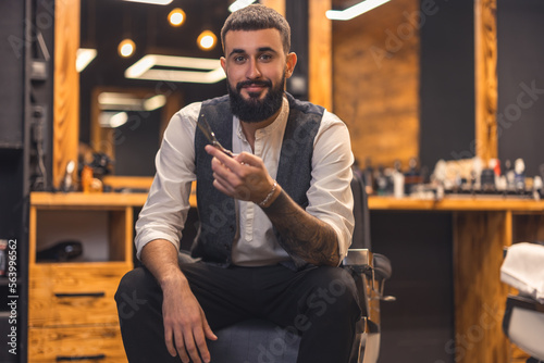 Handsome stylish barber at this working place photo