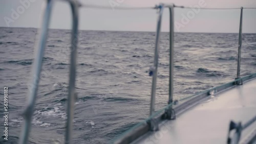 The white yacht is sailing on the waves. Slow motion