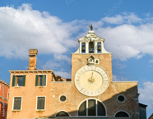Exterior of the church of San Giacomo di Rialto in the sestiere of San Polo, with a large 15th-century clock on the façade, Venice, Italy