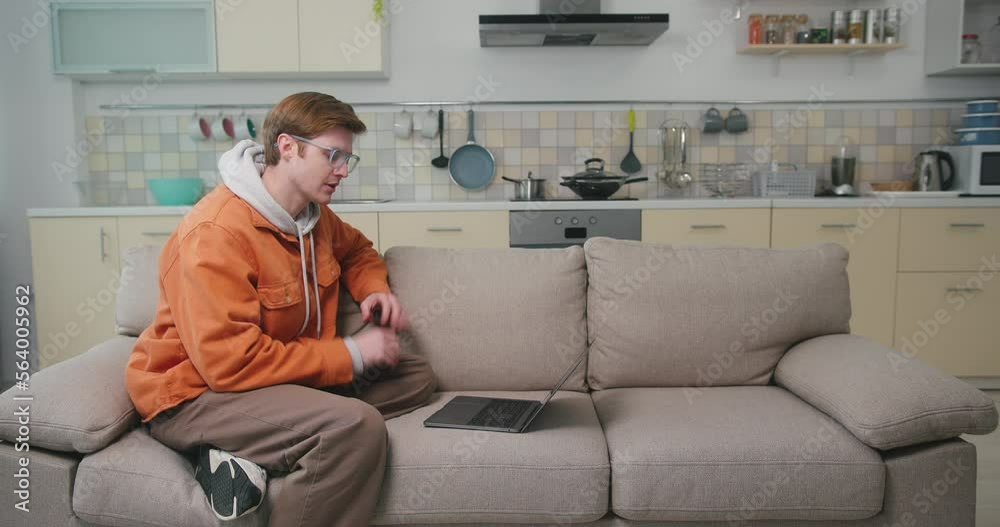 Young man talks on videocall explaining plans for content Young man talks on videocall explaining plans for content