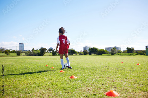 Soccer, mockup or sports and a girl training alone with a ball on a field for practice or skill. Fitness, football and grass with a kid running or dribbling on a pitch for competition or exercise