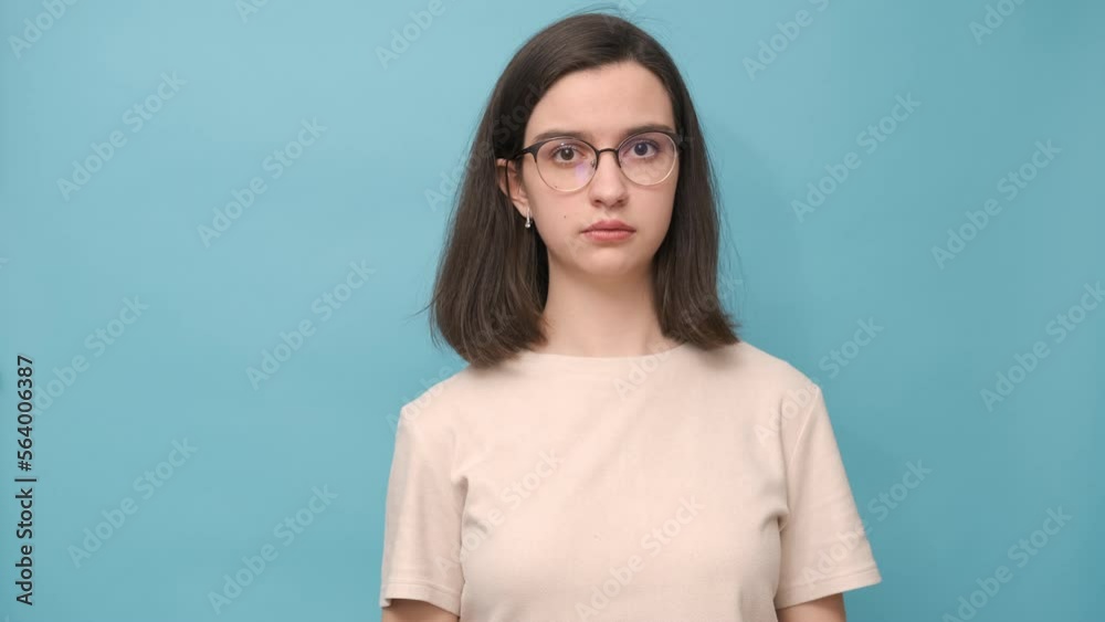 Portrait of a student girl with glasses and a beige blouse covering her ears, mouth, eyes, 4 K. Nonverbal communication. The girl shows that she sees nothing, hears nothing, will not tell anyone Portrait of a student girl with glasses and a beige blouse covering her ears, mouth, eyes, 4 K. Nonverbal communication. The girl shows that she sees nothing, hears nothing, will not tell anyone
