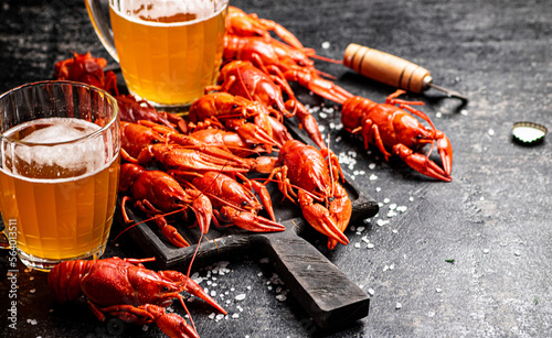 Boiled crayfish with beer on a cutting board. 