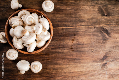 A wooden plate full of fresh mushrooms. 