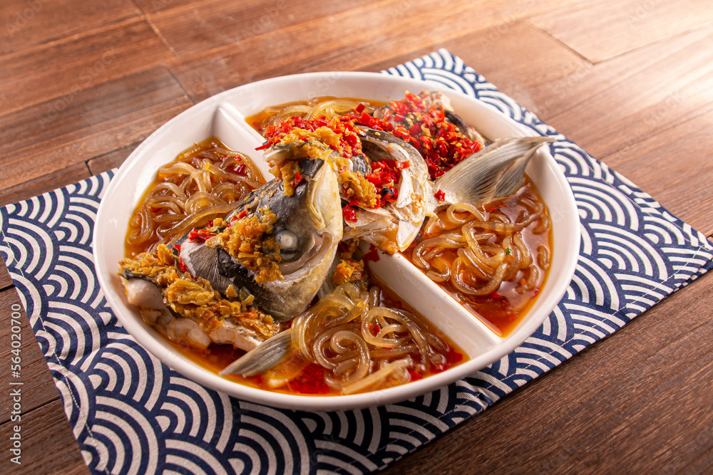 Spicy chilli Mao Xiang Big Fish Head with Fish Pork, Bean Pork with Potato Flour served dish isolated on wooden table top view of Hong Kong food Spicy chilli Mao Xiang Big Fish Head with Fish Pork, Bean Pork with Potato Flour served dish isolated on wooden table top view of Hong Kong food