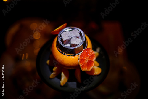 Obraz na płótnie Hookah on orange with smoke, with tangerine slices . High quality photo. Close-up photo w salonie