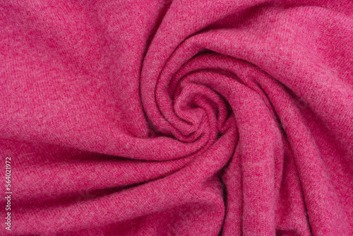 Twisted woolen fabric of magenta color close-up. Cashmere, fabric for a warm sweater concept. Place for your design