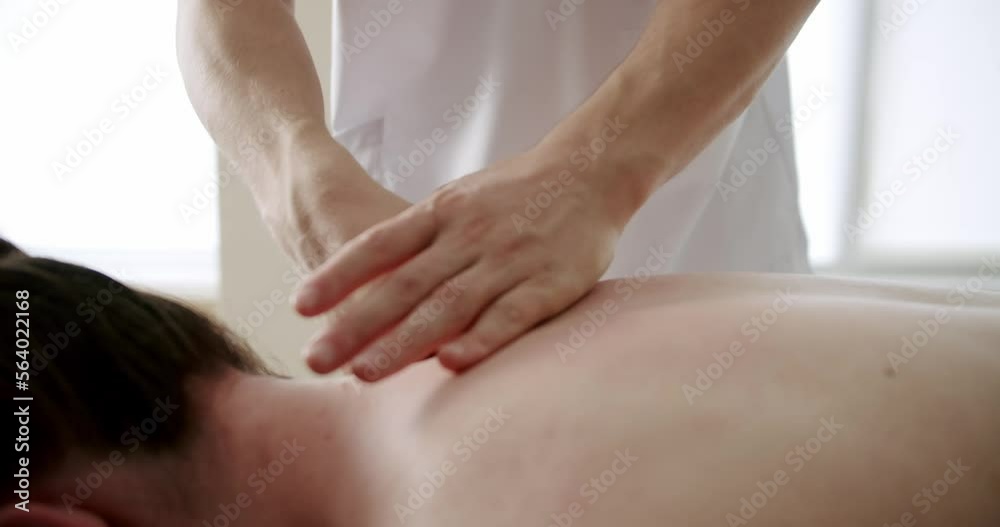 close-up filming of hands massaging back, rehabilitation massage in a professional massage parlor, professional masseur massaging the patient's back and shoulders. close-up filming of hands massaging back, rehabilitation massage in a professional massage parlor, professional masseur massaging the patient's back and shoulders.