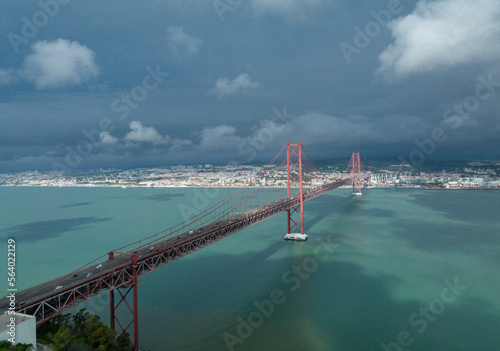 The 25 April bridge (Ponte 25 de Abril) located in Lisbon, Portugal, crossing the Targus river. Drone. photo