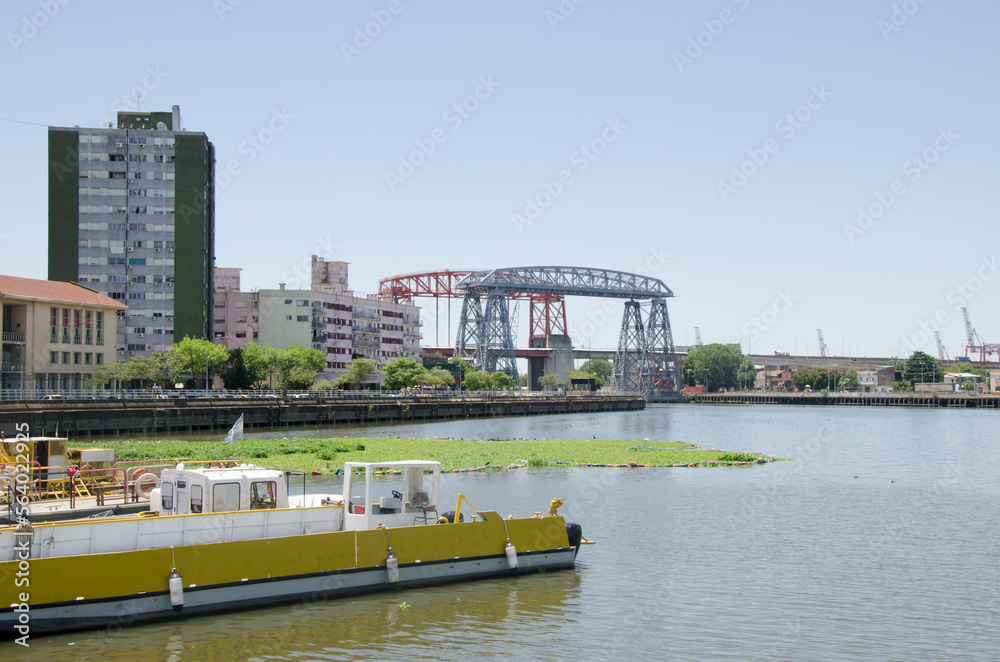 La Boca bridge in the city of Buenos Aires. bridge that divides the federal capital from the province of buenos aires with the stream under the bridge, with a boat