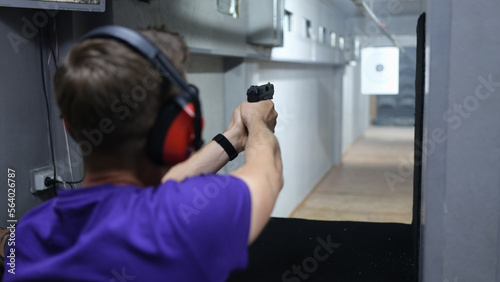 Shooter and instructor at shooting range.