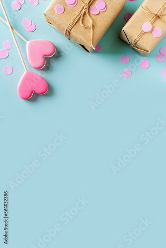 Candy pink lollipops with red gift box on blue background