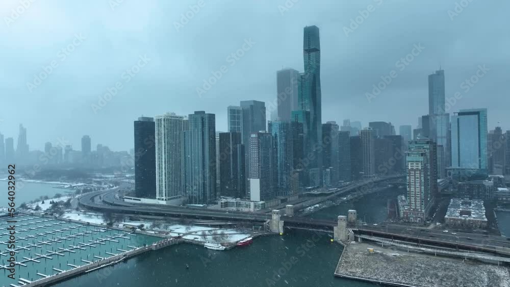 Drone aerial view of Chicago skyline from Lake Michigan flying over Chicago River snowing in winter on cloudy day Drone aerial view of Chicago skyline from Lake Michigan flying over Chicago River snowing in winter on cloudy day