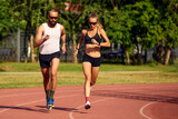 Woman and man jogging in the stadium
