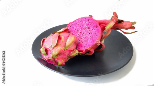 Pitahaya or dragon fruit is the fruit of the cactus.
Black dish on a white background.