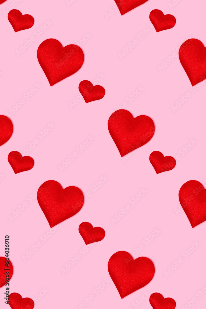 Repetitive pattern made of red hearts. Concept on a pink pastel background.