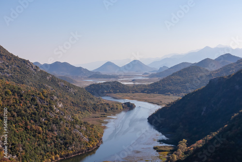 Scenic view from Pavlova Strana on horseshoe bend of river Crnojevica winding around Dinaric Alps mountains in Lake Skadar National Park, Bar, Montenegro, Balkans, Europe. Natural hilly landscape photo