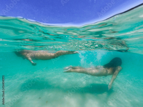 Two sisters swiming at Prainha Beach - .Arraial do Cabo, RJ, Brazil, Jan 19