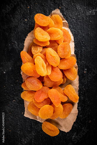 Dried apricots on a piece of paper on a table.