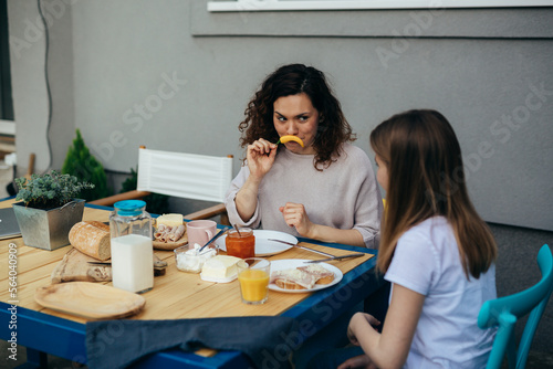 Mother and daughter are having fun in breakfast time