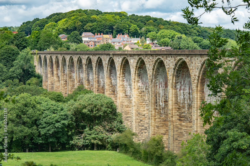 Railway viaduct with village in rear