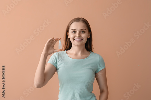 Young woman with eye drops ...