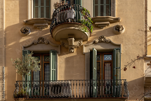 Photography The facade of the urban historic building front view with open balconies and woo