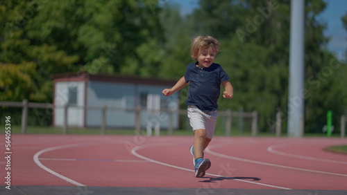 Little boy runner on running track