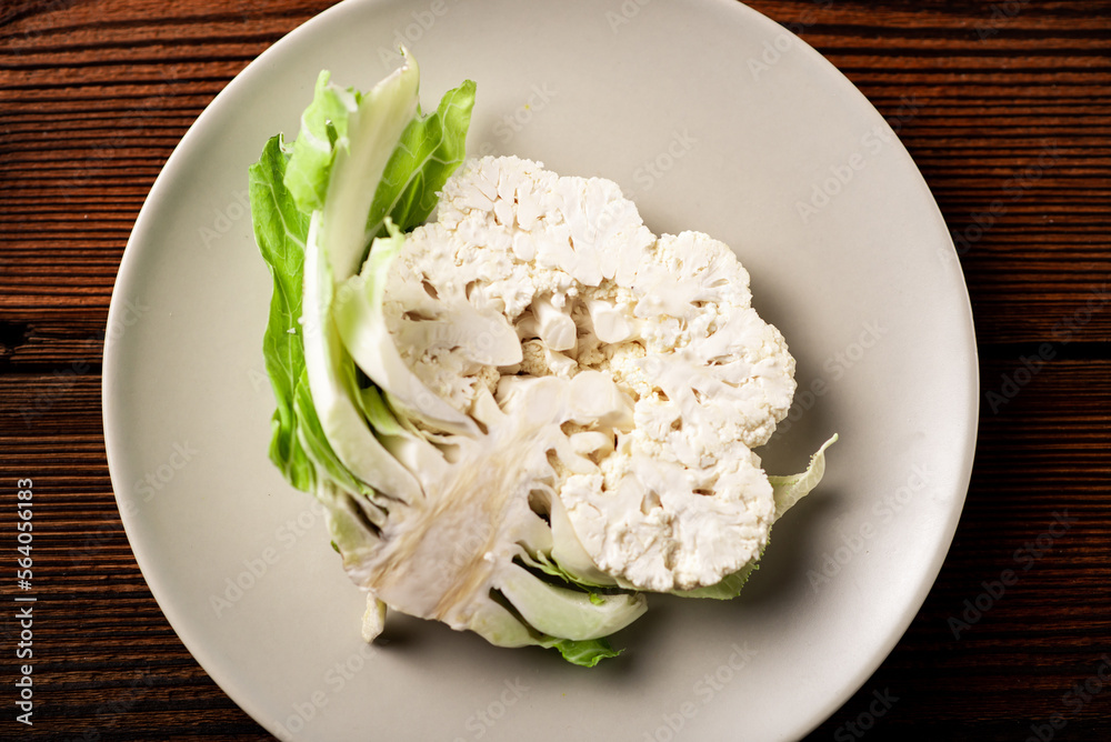 A piece of cauliflower close-up on a plate. Vegetarian concept, healthy eating. A piece of cauliflower close-up on a plate. Vegetarian concept, healthy eating.