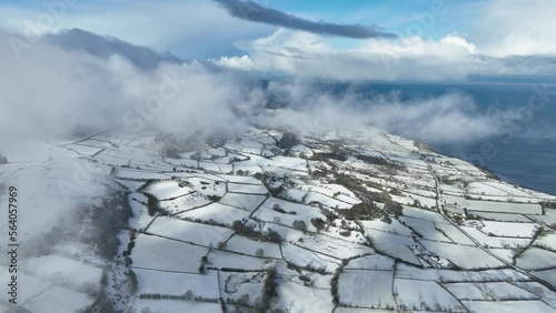 Aerial video of above freezing fog on a snowy Knockdhu Mountain County Antrim Northern Ireland photo