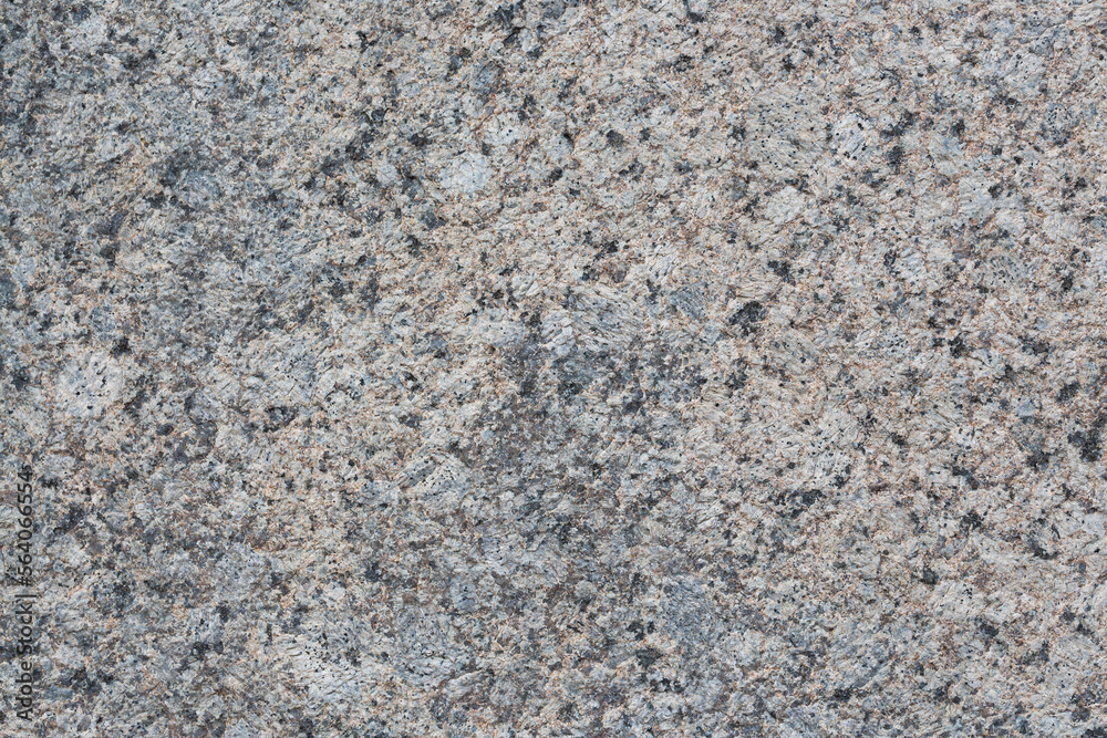 Granite texture. Natural gray granite with a grainy pattern. Stone background. Solid rough surface of rock. Durable construction and decoration material. Close-up. Granite texture. Natural gray granite with a grainy pattern. Stone background. Solid rough surface of rock. Durable construction and decoration material. Close-up.